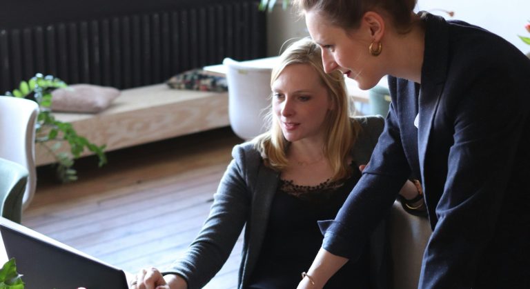 "Two executives in conversation, reflecting the internal work of coaching."